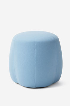 a light blue ottoman sitting on top of a white floor