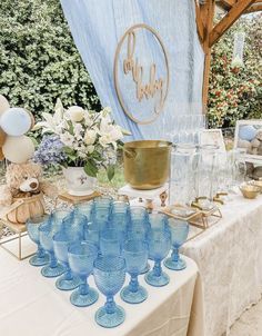 a table topped with lots of blue glasses