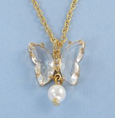 Sweet, graceful butterfly necklace features a butterfly pendant with clear crystal wings, tiny rhinestones between the wings and a white pearl bead dangle at the bottom. Makes a great gift for you, women, girls, butterfly and nature lovers. Pendant is 7/8 inches long and 3/4 inches wide. Necklace is inches long. See all photos for size reference. Gold plated necklace chain - 16, 18, 20, 22, 24, 30 inches long. All metal components are gold plated. Butterfly wing crystals are acrylic. Tiny rhines Crystal Wings, Coral Drop Earrings, Butterfly Wing Jewelry, Silver Initial Charms, Jewelry Butterfly, Butterfly Nature, Butterfly Necklace Gold, Wing Jewelry, Crystal Butterfly