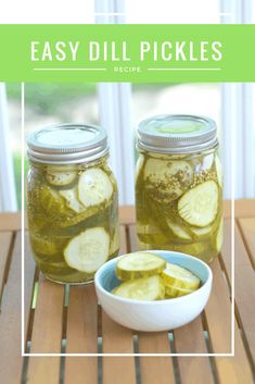 two jars filled with pickles sitting on top of a wooden table