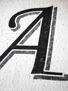 the letter a is made up of black and white tiles