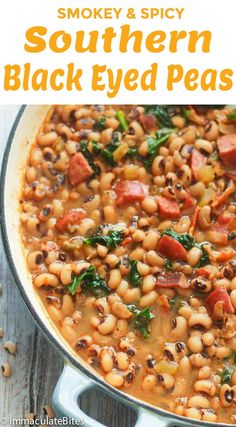 a pot filled with black eyed peas and spinach on top of a wooden table