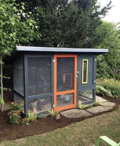 a small chicken coop in the middle of a yard