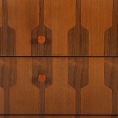 a wooden dresser with three drawers and two knobs on each drawer, all in different shapes and sizes