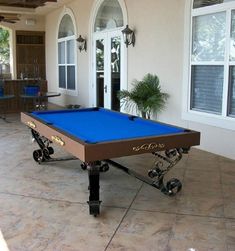 a blue pool table sitting in front of a house