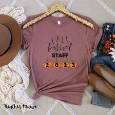 "🍂 Step into the enchanting world of autumn with our \"Fall Festival Staff 2023\" T-shirt! 🎃 🌟 Celebrate the Season: Embrace the spirit of fall with this charming tee, featuring a cute fall print on the front that captures the essence of this magical season. The adorable pumpkins add a touch of seasonal delight, making it a must-have for all autumn enthusiasts. 🍁 Official Staff Apparel: Proudly show your affiliation with the Fall Festival 2023 as staff with this exclusive T-shirt. Whether yo Fall Festival Shirt Designs, Festival 2023, Festival T Shirts, Fall Events, School Event, Fall Prints, Pumpkin Print, Hard Work And Dedication, Long Hours