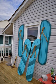 a pair of blue flip flops sitting on the side of a house