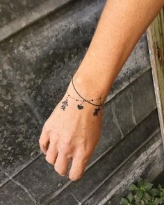 a person's hand with a small tattoo on it