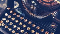 an old fashioned typewriter sitting on top of a table