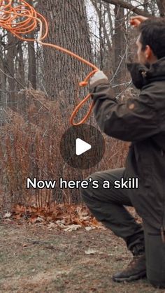 a man holding an orange rope in front of a tree with the words now here's a skill