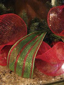 two red and green mesh balls on top of a granite counter next to a christmas tree