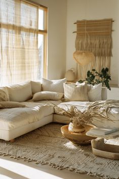 a living room filled with lots of furniture and pillows