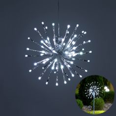 a white firework hanging from the ceiling in front of a black background and an image of a tree