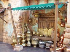 an outdoor area with pots and pans on display