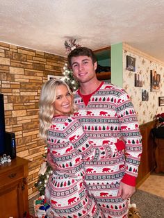 a man and woman in matching christmas pajamas