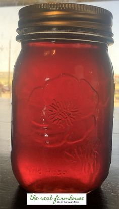 a red mason jar sitting on top of a table