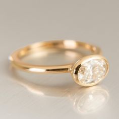 a gold ring with a white diamond on it