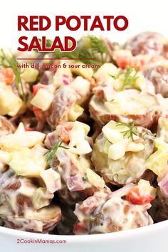 red potato salad with dill, bacon and sour cream in a white serving bowl