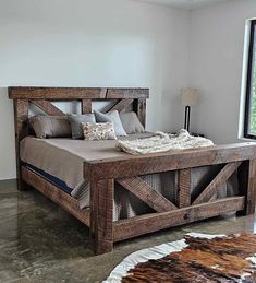 a bed made out of wooden planks in a room with a cowhide rug on the floor