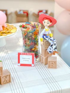 Toy Story's Jessie sitting on blocks next to there's a snake in my boot gummy worms on a dessert table Classy Toy Story Party, Toy Story Bo Peep Birthday Party Ideas, Toy Story 1st Birthday Party Ideas Girl, Forky Birthday Theme, Toy Story Party Table Setting, Toy Story 3rd Birthday Party Girl, Toy Story Decorations Party, Toy Story 6th Birthday Party Ideas