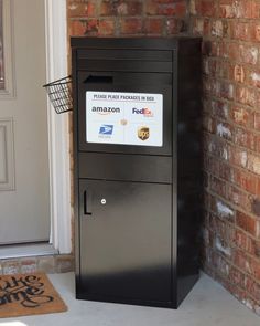 a mailbox sitting in front of a brick wall next to a door with an amazon sticker on it