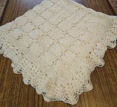 a white crocheted doily on a wooden table