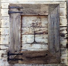 a wooden frame with a tree painted on the side and branches growing out of it