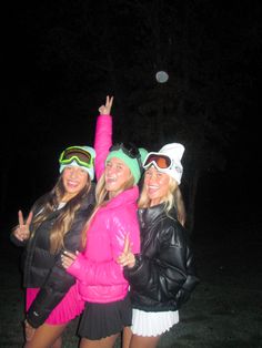 three women in ski gear posing for the camera