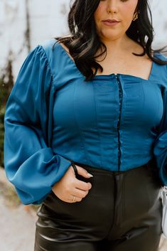 Teal crop top Corset hook enclosures along front Long sleeve w/ stretching cuff Smocked back 95% Poly + 5% Spandex Non-sheer Semi-stretching Fit: True to size. SIZE CHART (Measured in inches) Size Fits Like Length Bust 1XL 12/14 20 40 2XL 16 20.5 42 3XL 18/20 21 46 Model Specs Kennedy is wearing a 1XL. Height: 5'8 Size: 14 Fitted Crop Top For Brunch In Fall, Fitted Crop Top For Fall Brunch, Stretch Crop Top For Brunch In Fall, Fitted Blue Crop Top With Square Neck, Blue Fitted Crop Top With Square Neck, Fitted Blue Square Neck Crop Top, Teal Corset, Teal Crop Top, Top Corset