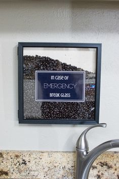 there is a sign that says in case of emergency break glass hanging on the wall