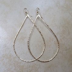 "Gold Teardrop Hoop Earrings~ Beautiful handmade hammered teardrop hoop earrings, polished to a beautiful shine for an elegant look! Choose from sizes ~ SMALL approx. 1\" MEDIUM approx. 1.5\" LARGE approx. 2\" width of the hoop * model is wearing approx. 1.5\" width hoops. Made with 14k gold fill 16 gauge wire Also available in sterling silver ~ https://www.etsy.com/listing/119110728/teardrop-hoops-sterling-silver-hoop SHOP~ http://www.etsy.com/shop/HanaMauiCreations?ref=si_shop International bu Hammered Teardrop Earrings For Anniversary, Teardrop Hoop Earrings For Wedding, Elegant Teardrop Hammered Hoop Earrings, Hammered Teardrop Earrings, Metal Teardrop Earrings For Wedding, Adjustable Teardrop Hoop Earrings For Wedding, Hammered Hoop Earrings For Wedding, Hammered Hoop Jewelry For Wedding, Hammered Hoop Wedding Jewelry