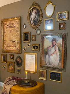 a wall with many framed pictures on it