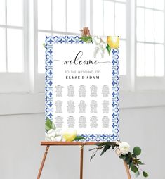 a welcome sign on an easel with flowers