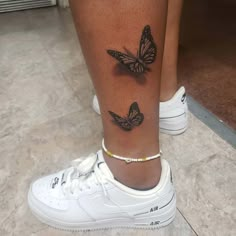 a woman's foot with two butterflies on the left side of her leg and an ankle tattoo