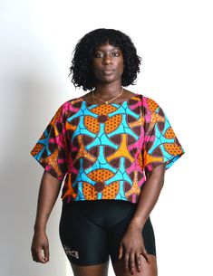 Stylish and Comfortable: this African crop top with short sleeves is not only trendy but also perfect for warm weather. The short sleeves provide a balanced look, keeping you cool and stylish in the summer months. Ankara Kimono Dress, African Crop Top, Ankara Crop Top, African Kimono, African Clothing Stores, African Tops, African Inspired Fashion, Ruffled Top, African Clothing Styles