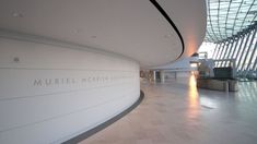 the interior of an airport terminal with large windows and white walls, along with marble flooring