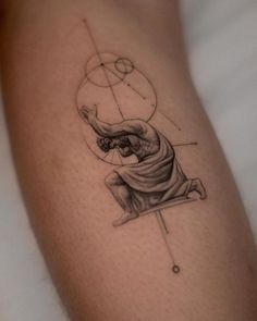 a tattoo on the leg of a person with an image of a man holding a ball