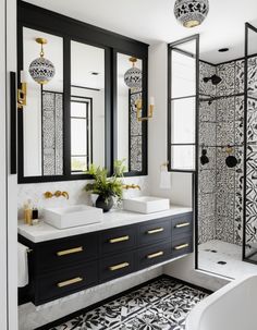 a black and white bathroom with gold accents