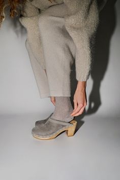 Slipper meet clog, clog meet slipper. Now on high heel base. Sheepskin upper. Perfect for when the weather starts to get cold. We love this for indoors and outdoors. Surprisingly comfortable for a high heeled shoe. Smoke is a cool grey suede with a dark grey shearling. Initial fit may be snug, upper will stretch and give with wear. Every clog is handmade. Certain styles may take up to 10 business days to arrive. DETAILS Sheepskin and cow leather upper. Wood base with polyurethane sole. 3" heel w Clogs Outfits, No 6, Gray Suede, Printed Leather, Back Strap, Cow Leather, High Heel Shoes, High Heel, Open Back