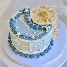 there is a blue and white cake with stars on the top that looks like an airplane