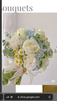 a bouquet of white and blue flowers is displayed on the front cover of a magazine