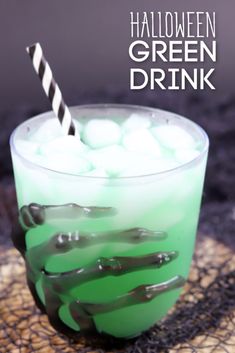 a halloween drink with green liquid and marshmallows