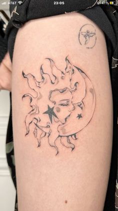 a woman's thigh with a tattoo on the side of her leg that has an image of a moon and stars coming out of it