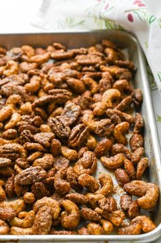 a metal pan filled with nuts on top of a table