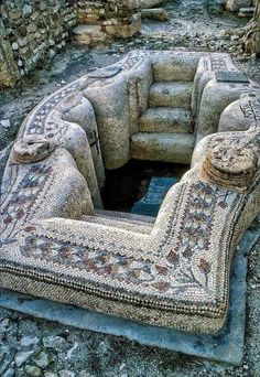 an old couch made out of rocks and stones