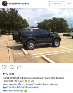 a black truck parked in a parking lot