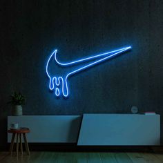 a neon sign that is on the side of a wall