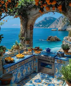 an outdoor kitchen with blue tile and oranges on the counter top, overlooking the ocean