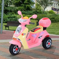 a pink and yellow scooter is parked on the sidewalk