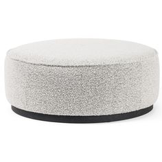 a white and black ottoman sitting on top of a table